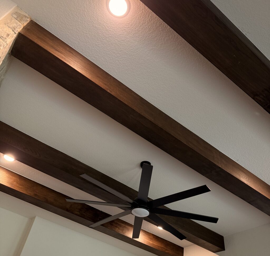 Decorative faux wood ceiling beams in an open concept living room in Austin