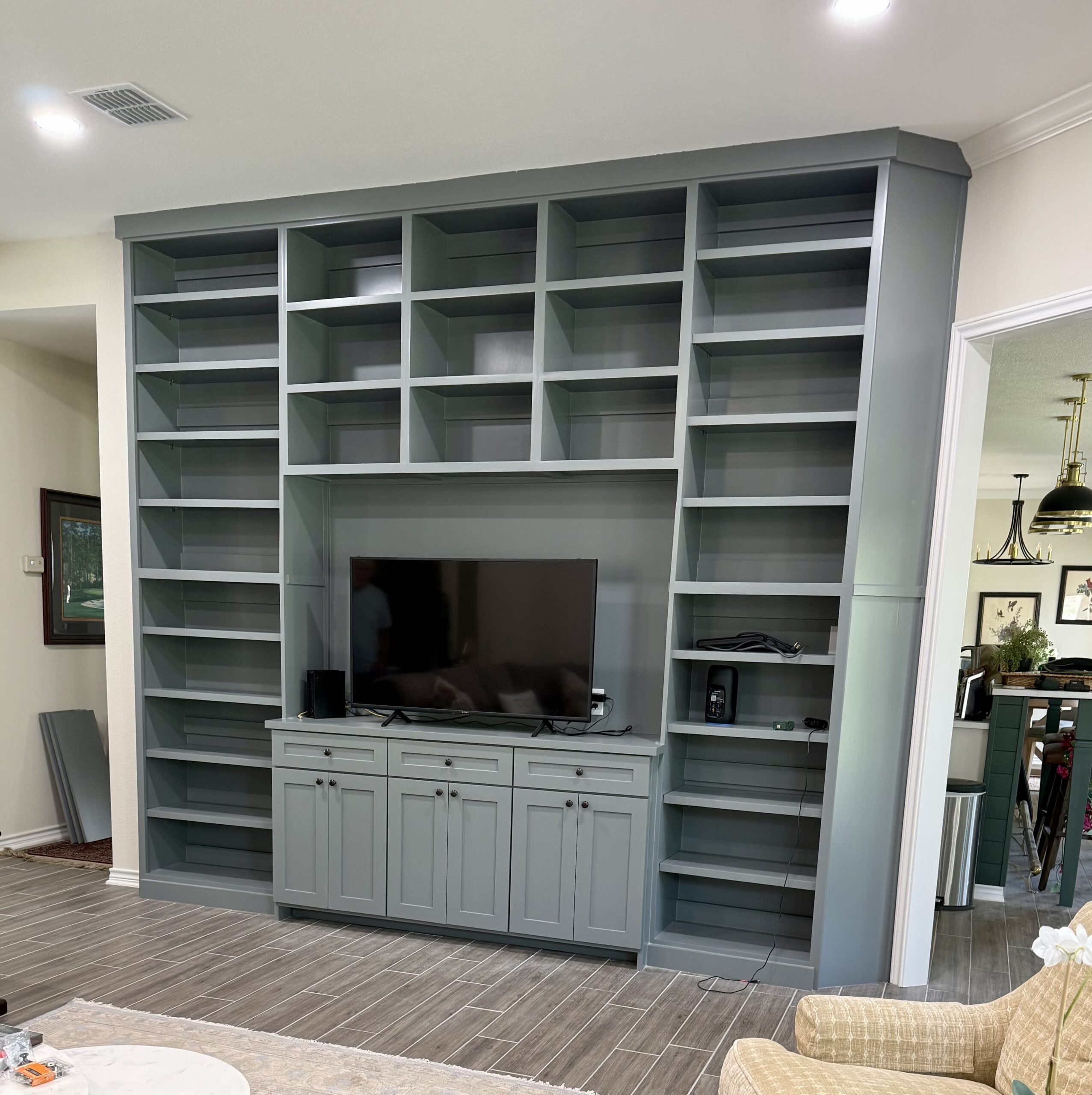 Builder grade home transformed with custom accent wall, ceiling beams, built-ins, and trim in Austin